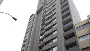 A tall, modern building with multiple floors and balconies. - RQ City Center (Santiago)