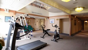 A hotel fitness center with treadmills, stationary bikes, and a stair climber.