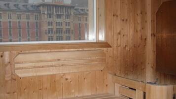 A wooden interior with a large window overlooking a building with a dome.