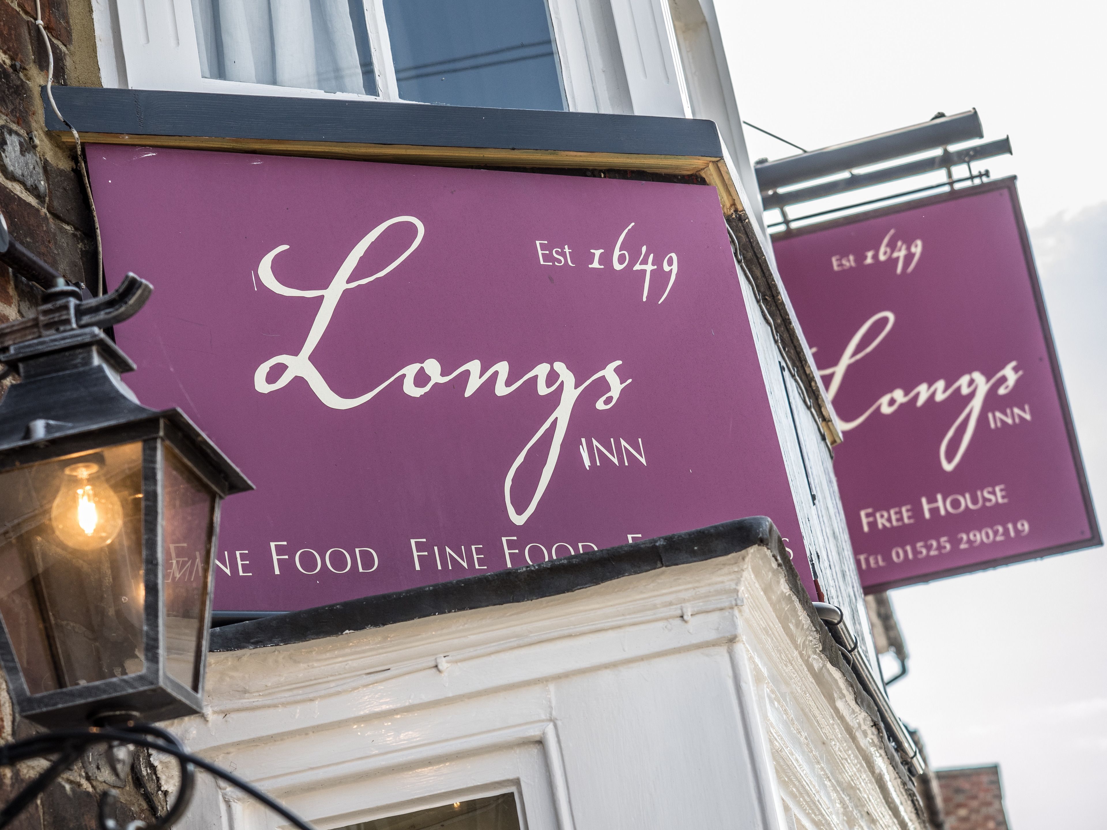 A building with a sign that reads "Longs Inn" and "Est 1649".