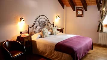 A bedroom with a bed, two bedside tables, a chair, and a window with curtains.