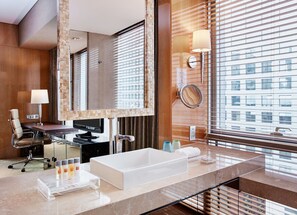 A modern bathroom with a large mirror, a sink, a chair, and a desk with a computer. - Crowne Plaza Beijing Chaoyang U-Town by IHG (Beijing)