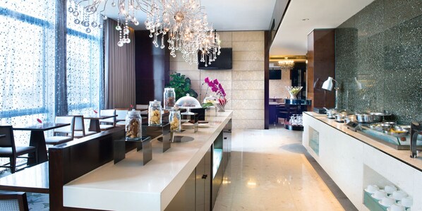 A modern hotel lobby with a long reception counter, seating area, and a decorative chandelier. - Crowne Plaza Beijing Chaoyang U-Town by IHG (Beijing)