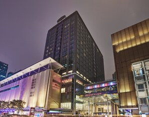 A multi-story building with a prominent sign for Crowne Plaza. - Crowne Plaza Beijing Chaoyang U-Town by IHG (Beijing)