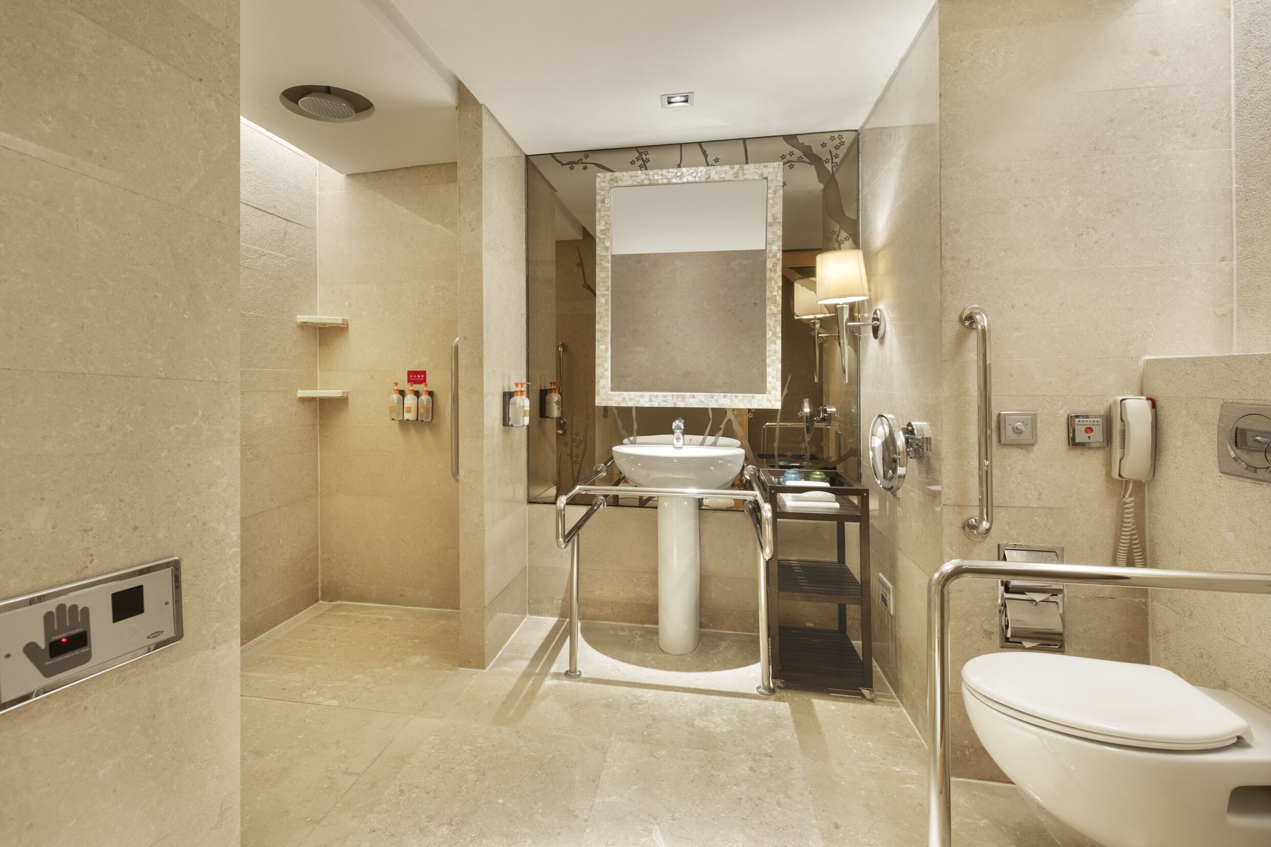A modern bathroom with a large sink, mirror, and toilet.