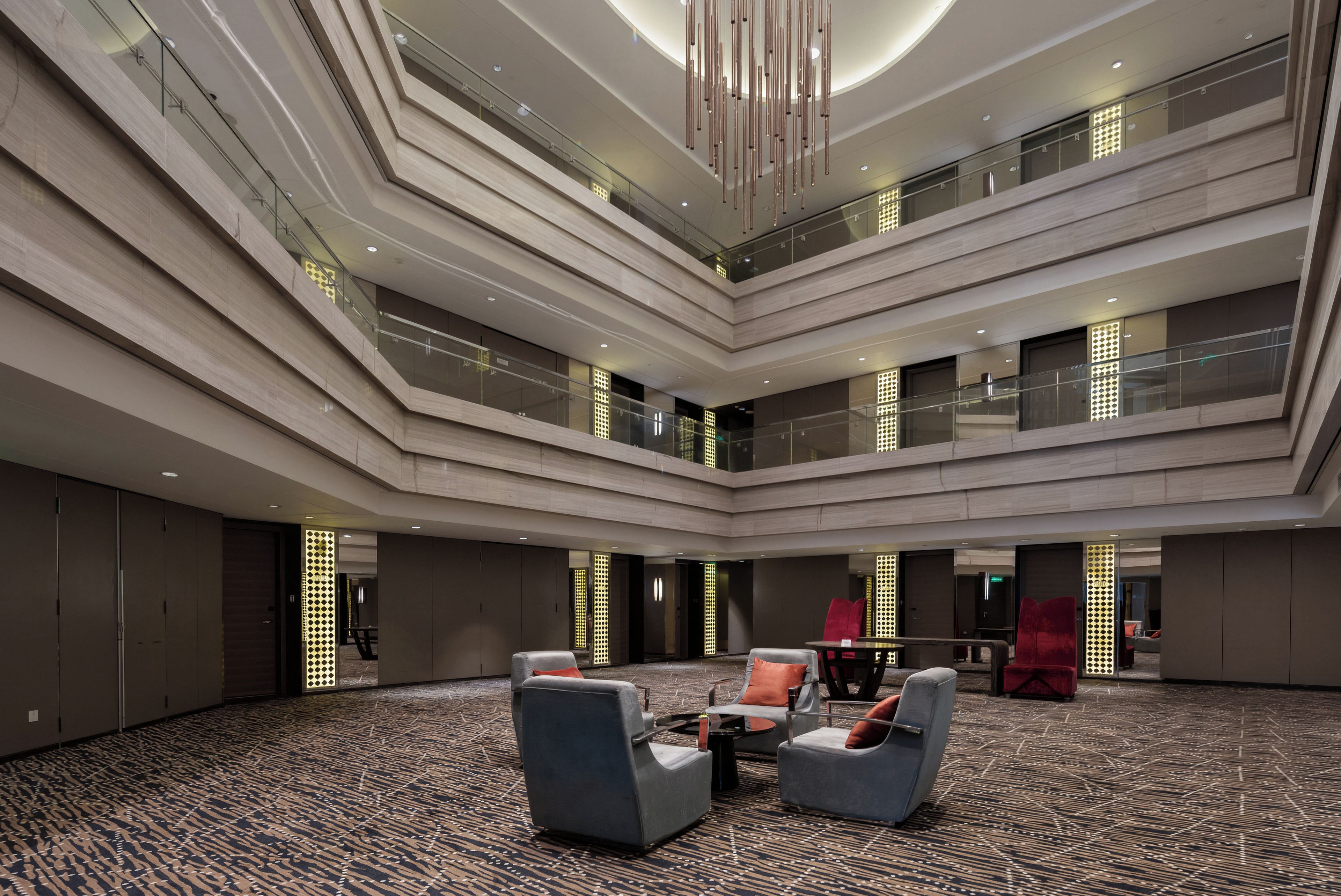 A multi-level atrium with modern furnishings and a patterned carpet.