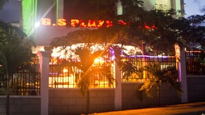 A building with a prominent clock tower, large windows, and a sign that reads "G.S. Plaza". - GS Plaza Hotel (Accra)