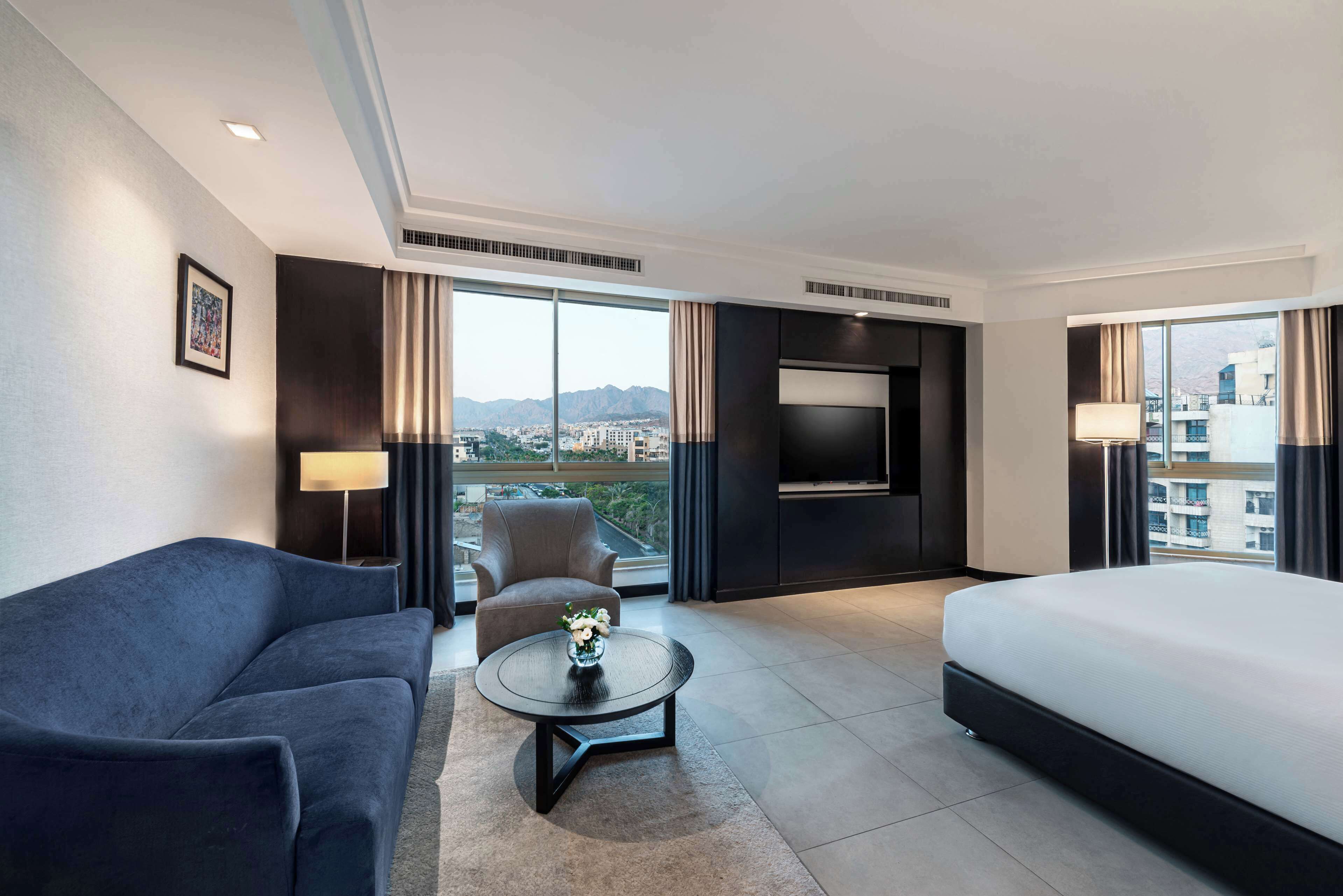 king deluxe corner room with city view | living area | 43-inch lcd tv with satellite channels, tv