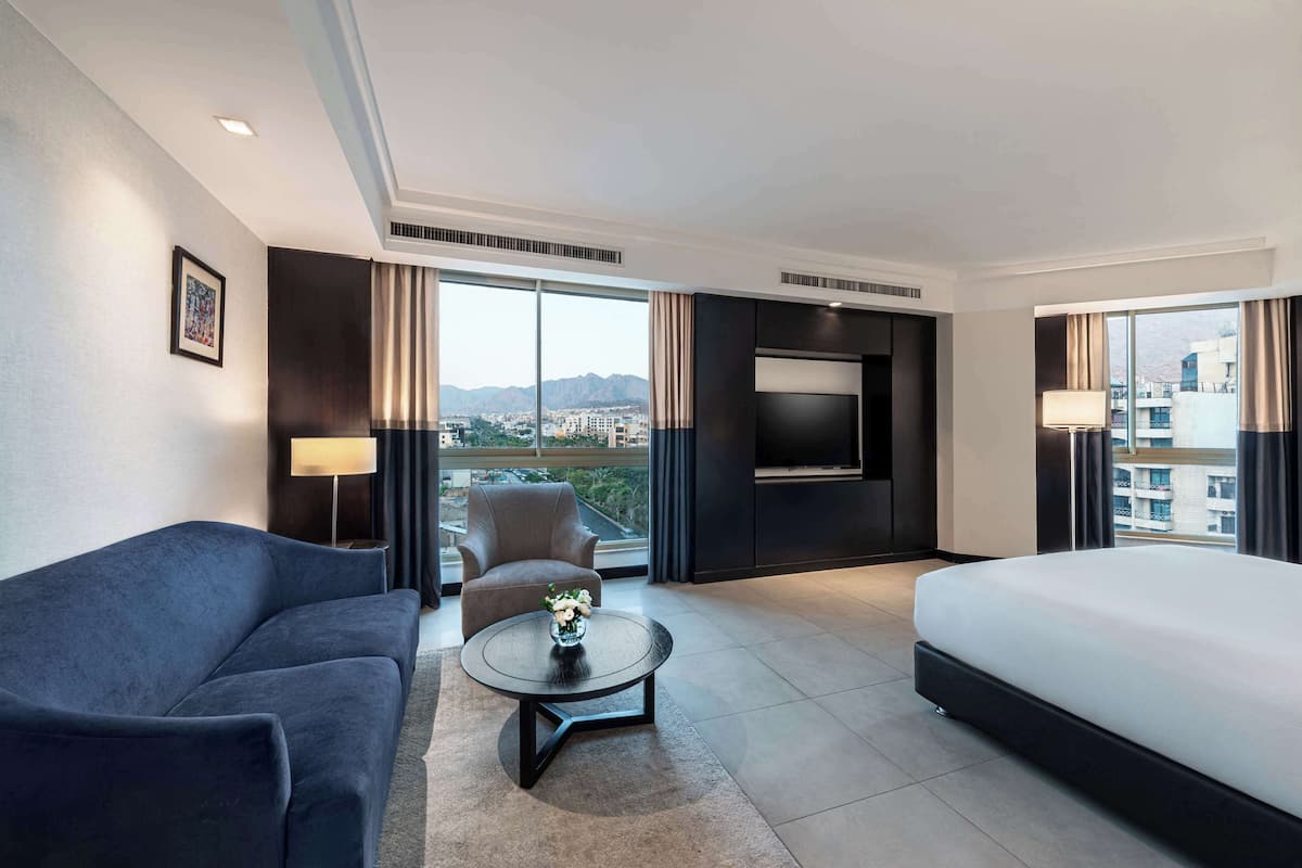 king deluxe corner room with city view | living area | 43-inch lcd tv with satellite channels, tv