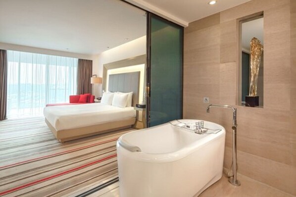 Suite ejecutiva, 1 cama de matrimonio grande | Baño | Artículos de higiene personal ecológicos, secador de pelo y albornoces