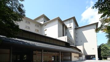 A modern building with a covered entrance and multiple windows.