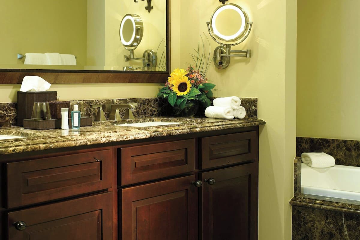 bathtub, deep-soaking bathtub, hair dryer, towels