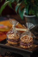 Two glass-encased food items with a string tied around the top, placed on a tray.