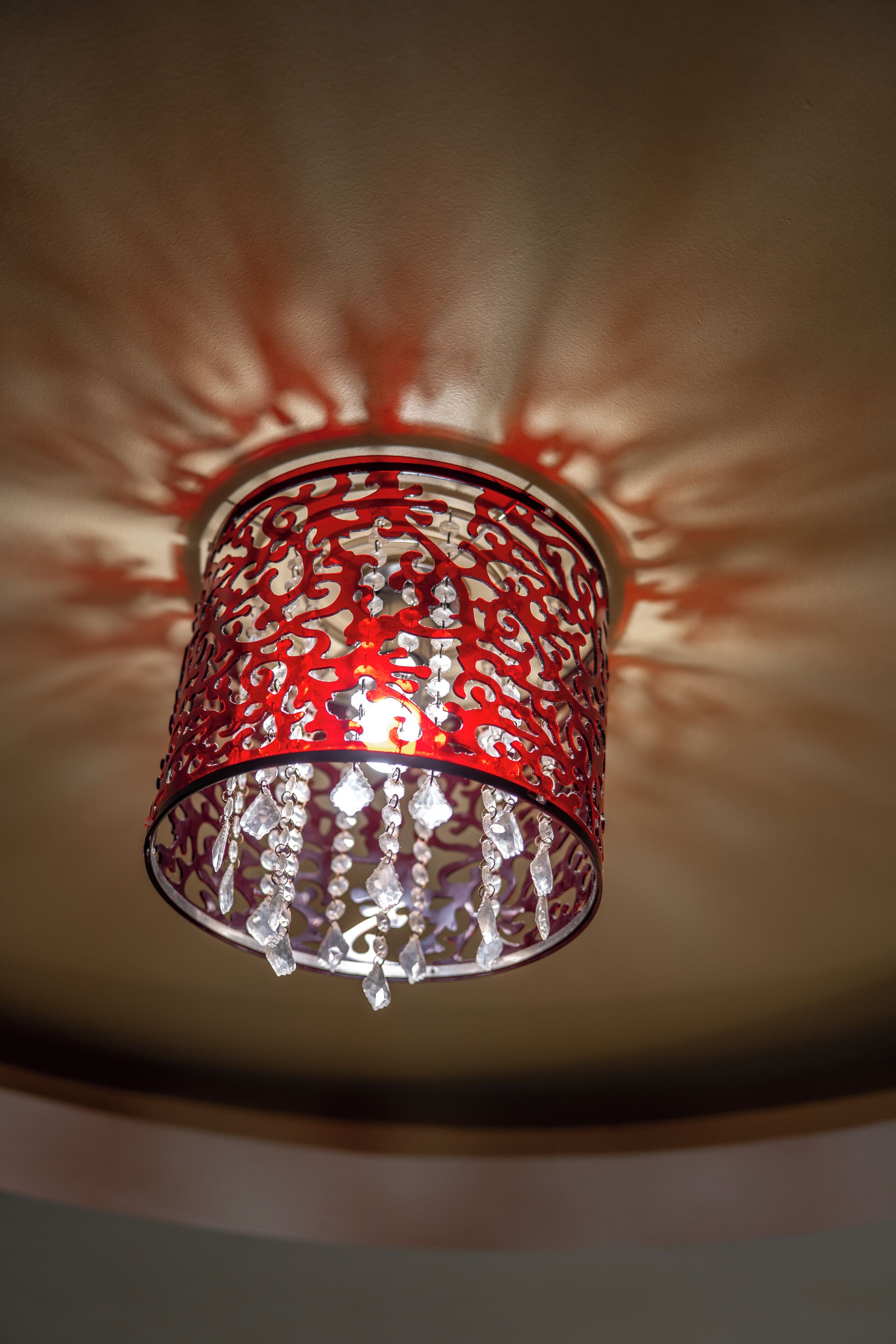 A red metal chandelier with crystal details.