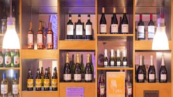 A bar area with shelves of various alcoholic beverages, including wine and gin.