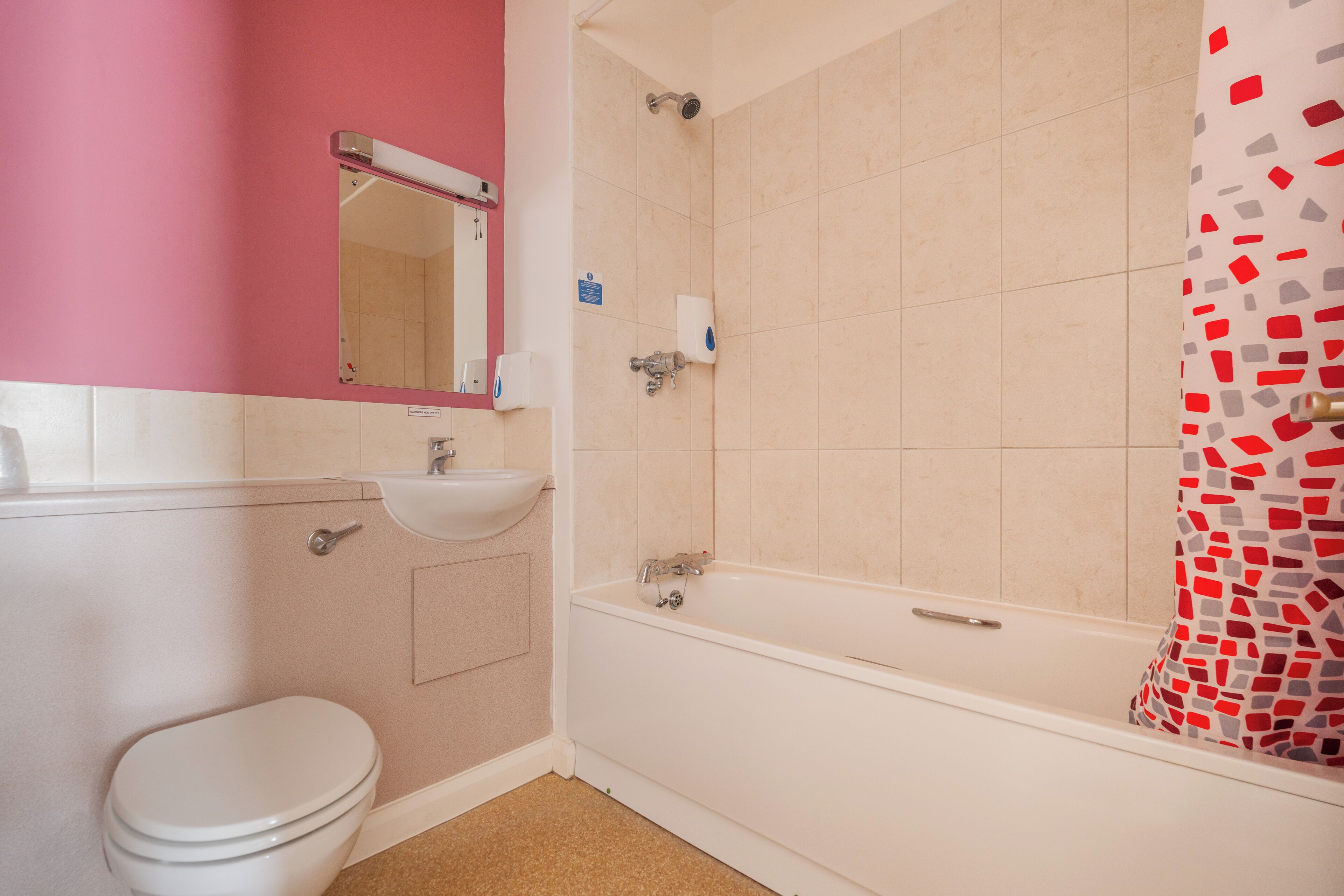 A bathroom with a toilet, sink, and bathtub.