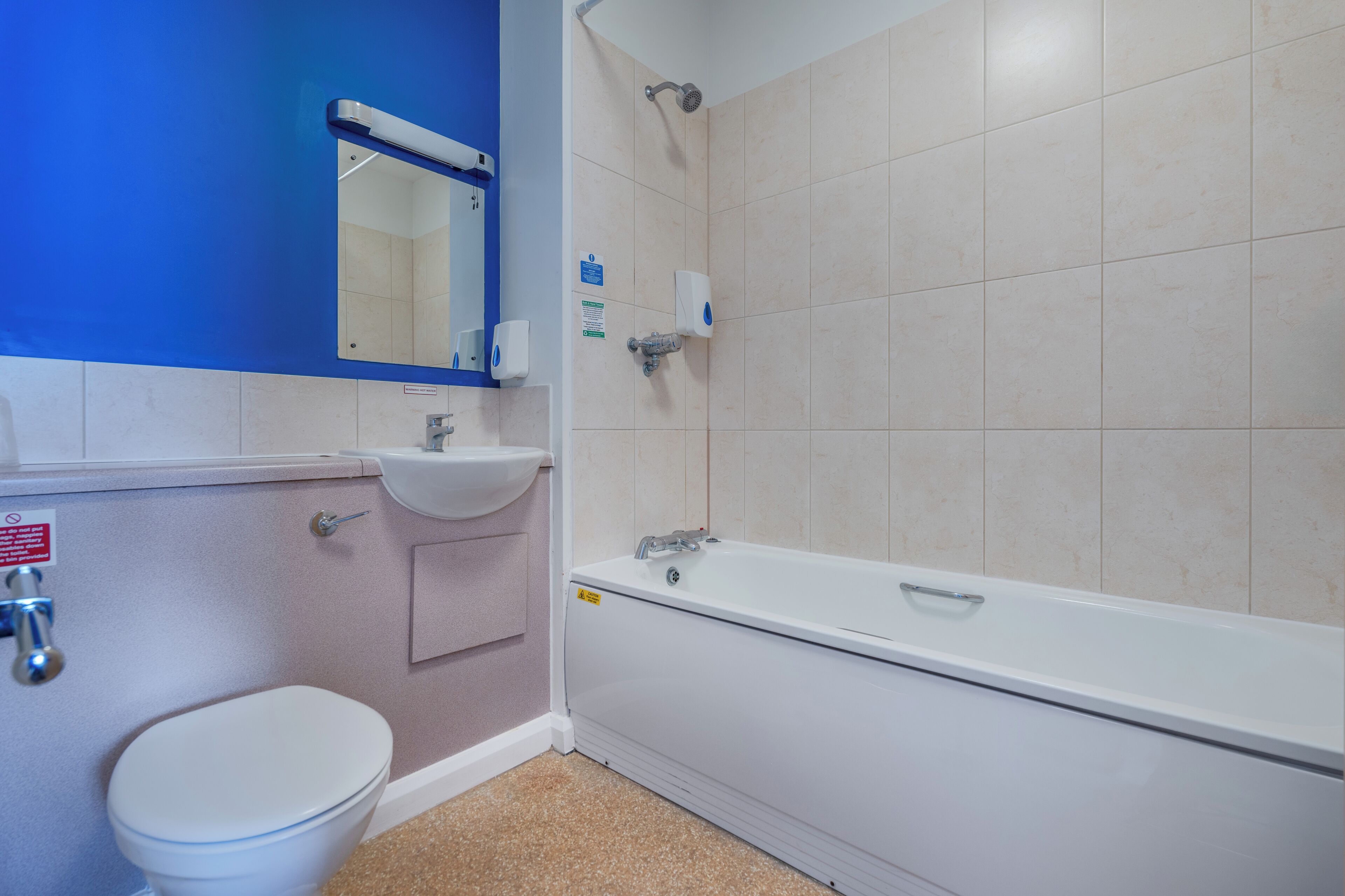A bathroom with a toilet, sink, and bathtub.