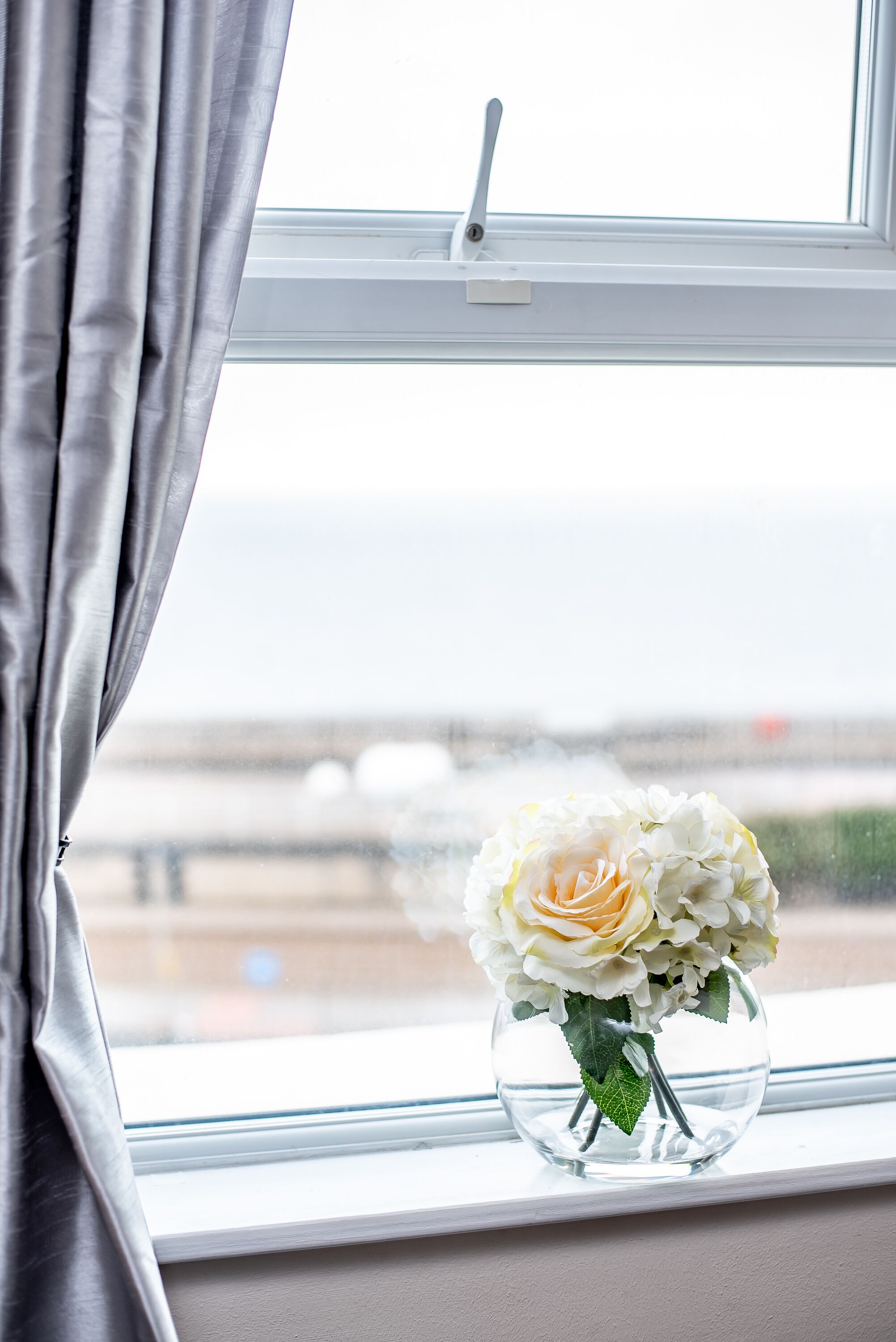 A window with a view of a bridge and a clear sky.