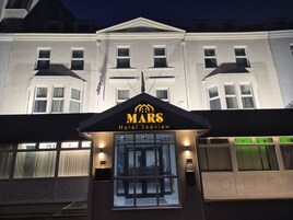 A hotel entrance with a sign reading "MARS Hotel Seaview."