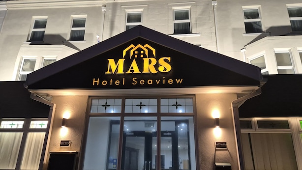 The exterior of the Mars Hotel Seaview with a prominent entrance and a sign above the doors.