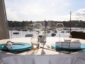 Enjoy a romantic dinner for two with a view of the marina through the large window.