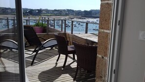 A balcony with a view of boats and a beach.