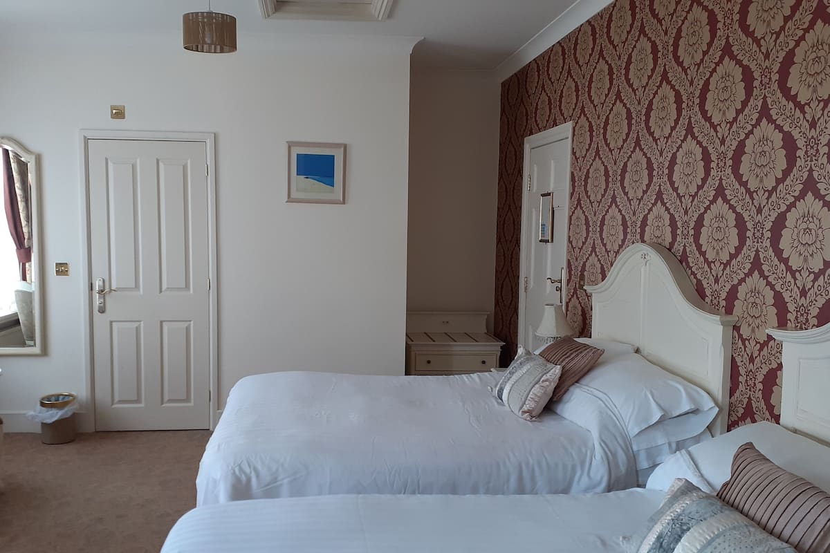 Premium bedding, desk, laptop workspace, blackout curtains