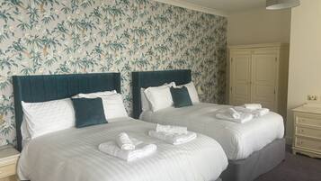 Premium bedding, desk, laptop workspace, blackout curtains
