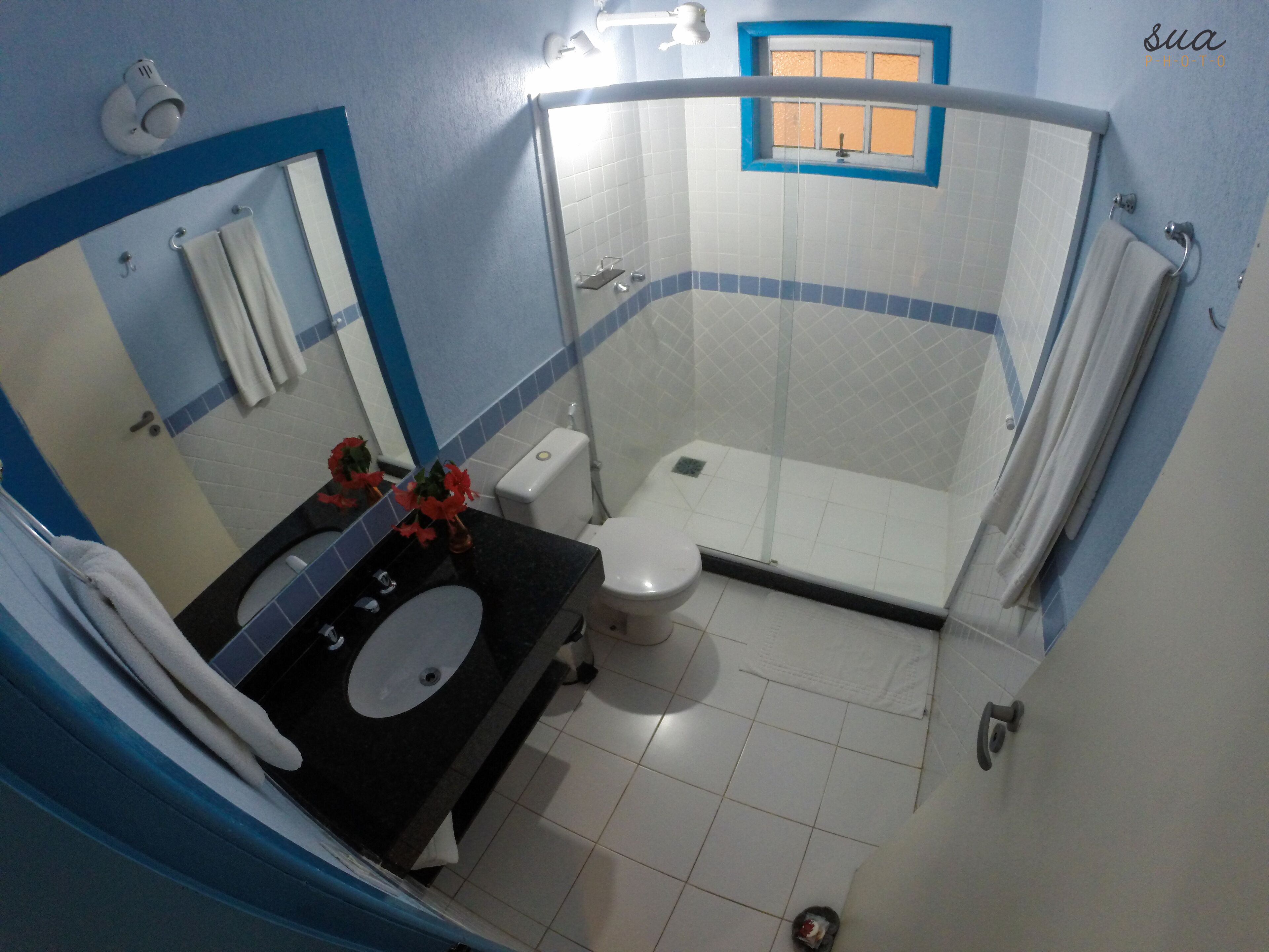 A bathroom with a sink, toilet, and shower.