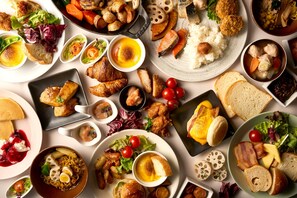 A variety of dishes including seafood, bread, and salads.