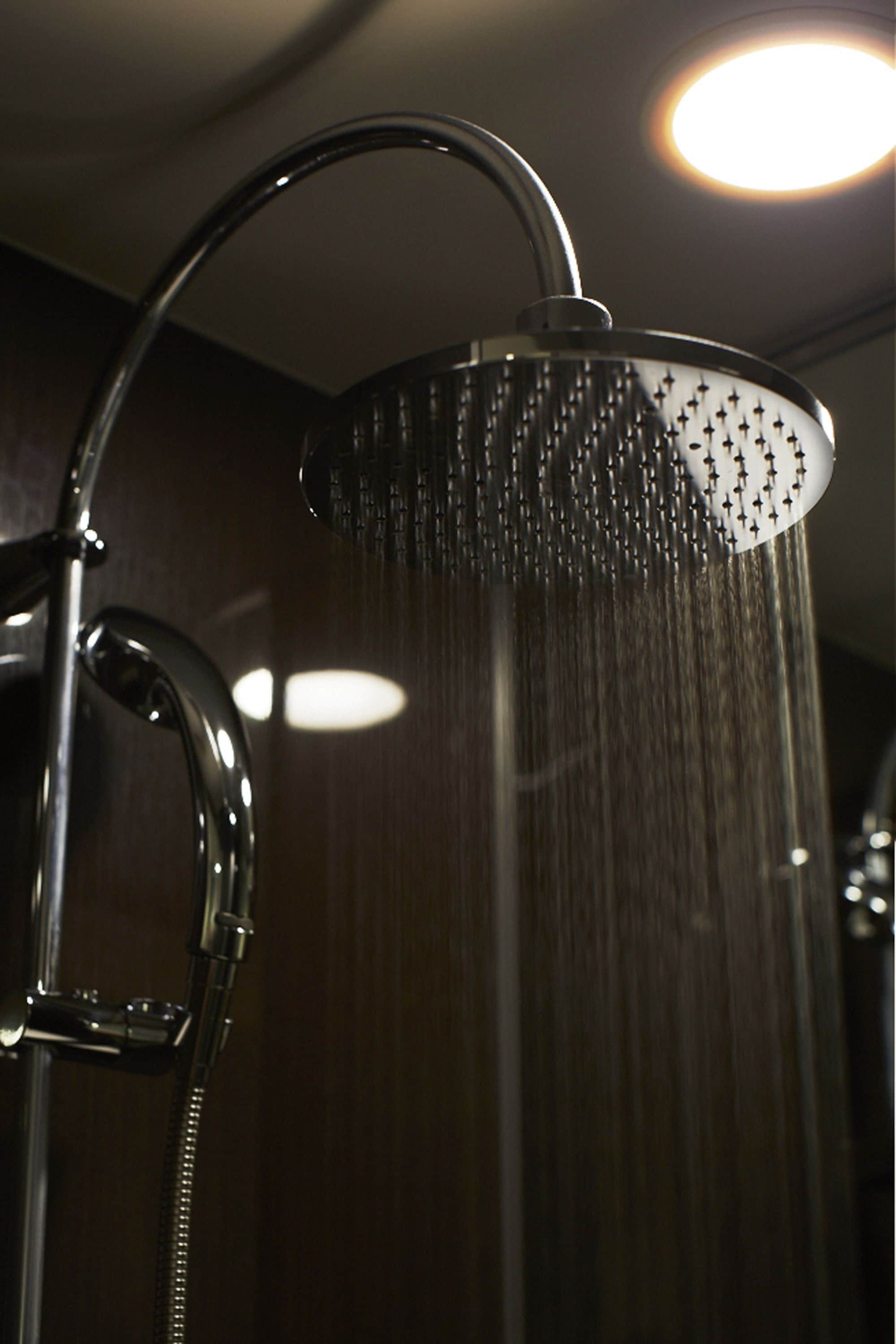 A showerhead with multiple nozzles, a curved handle, and a flexible hose.