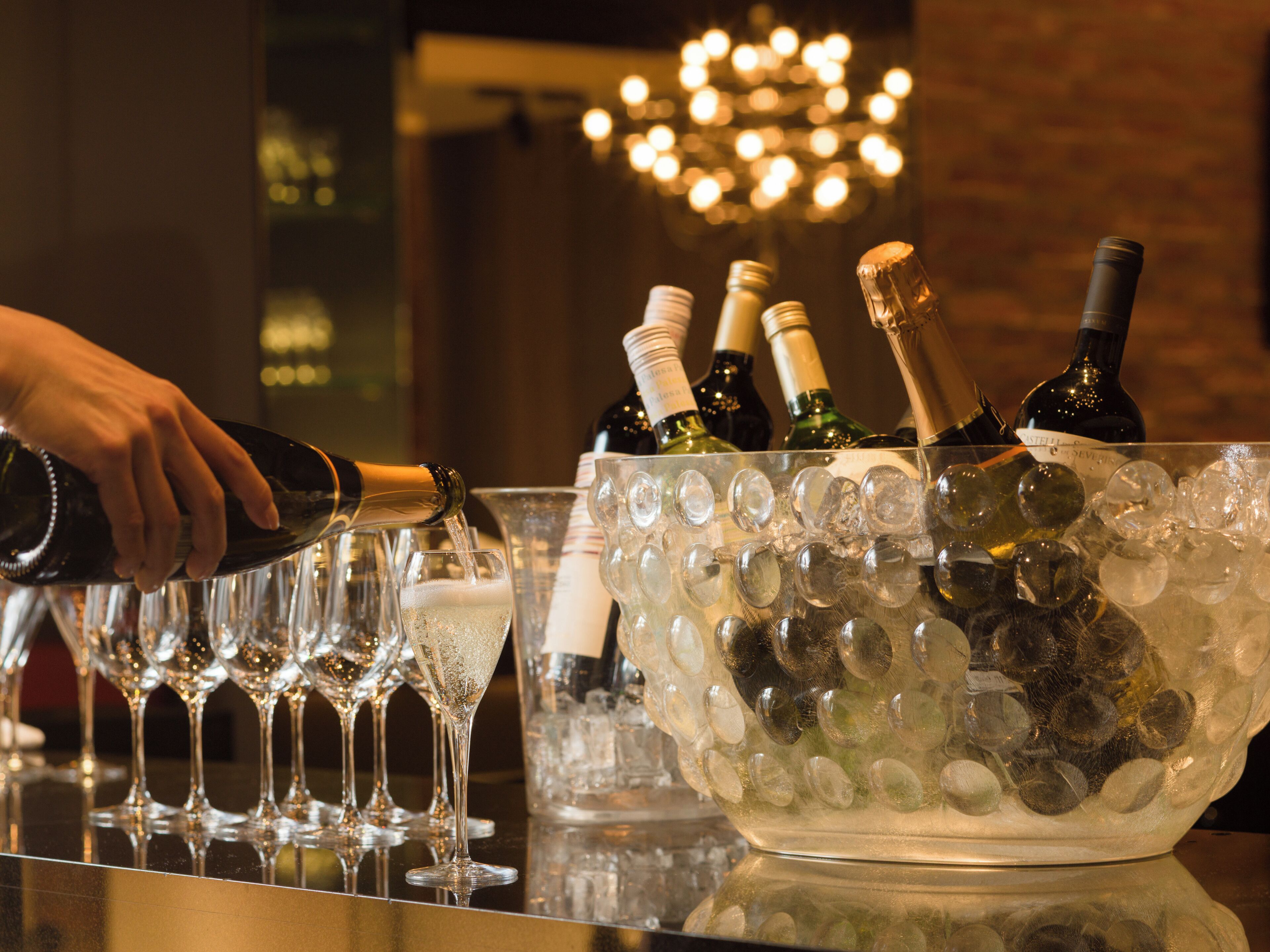 A bar area with a large ice-filled bowl containing bottles and glasses.