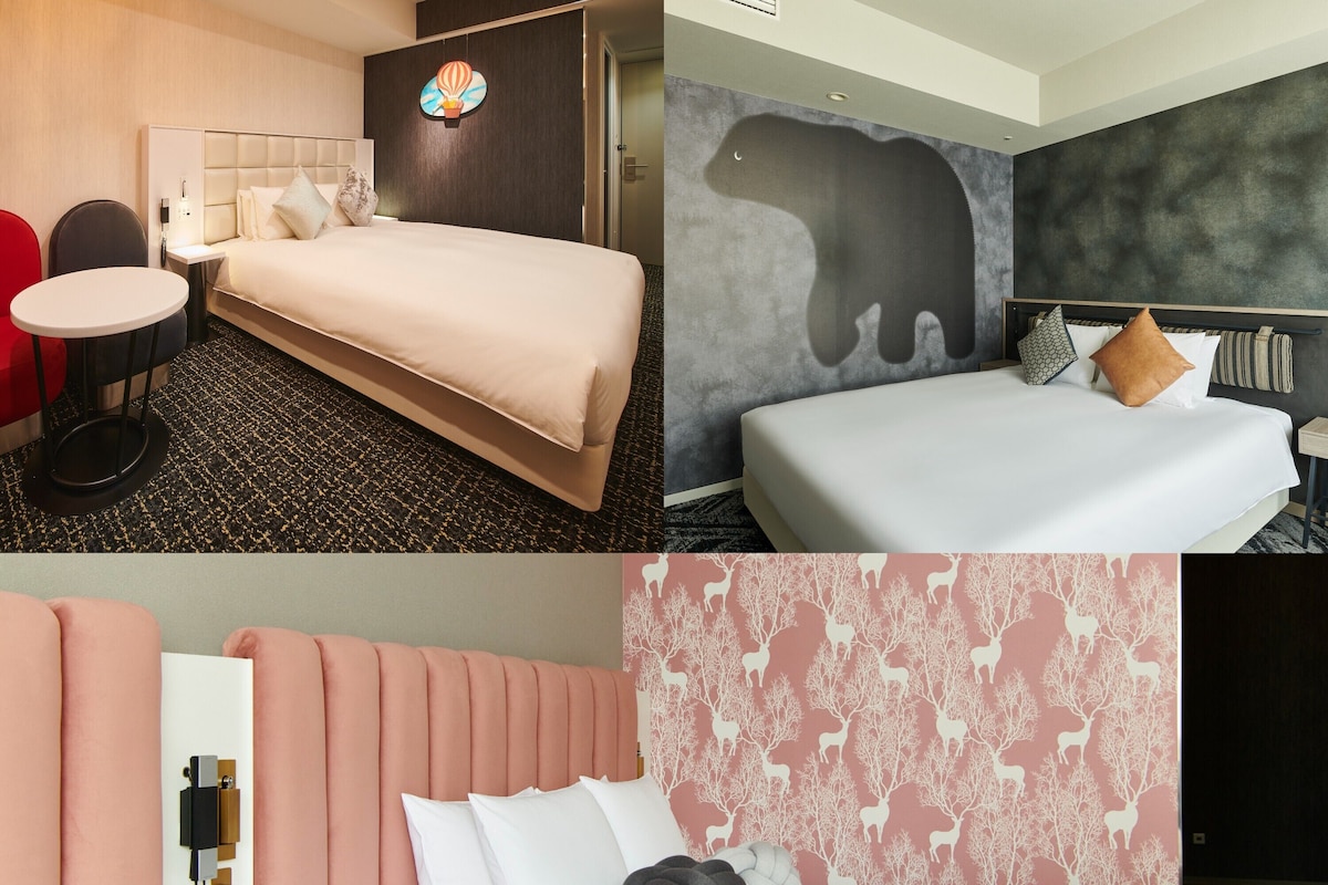 A hotel room with a bed, bedside table, and a small round table.