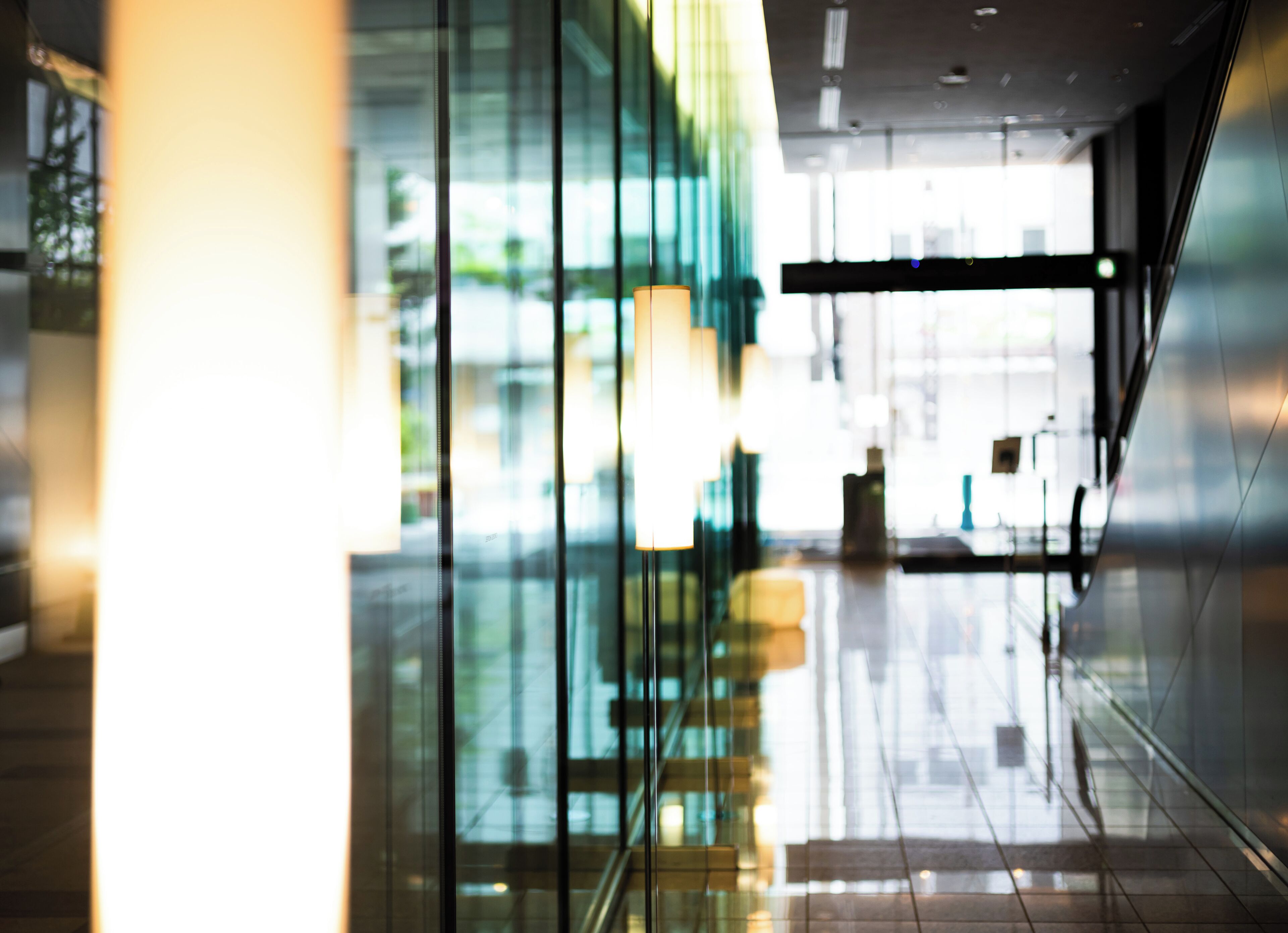 A modern interior with reflective glass walls and a clean, minimalist design.