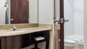 A bathroom with a sink, mirror, and toilet. - Red Roof Inn Darien - I-95/ North Brunswick (Darien)