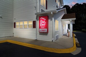 Un hotel Red Roof Inn con una entrada visible y una vista clara del área de recepción.