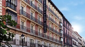 A multi-story hotel with balconies, a prominent sign, and classic architectural details. - Catalonia Plaza Mayor (Madrid)