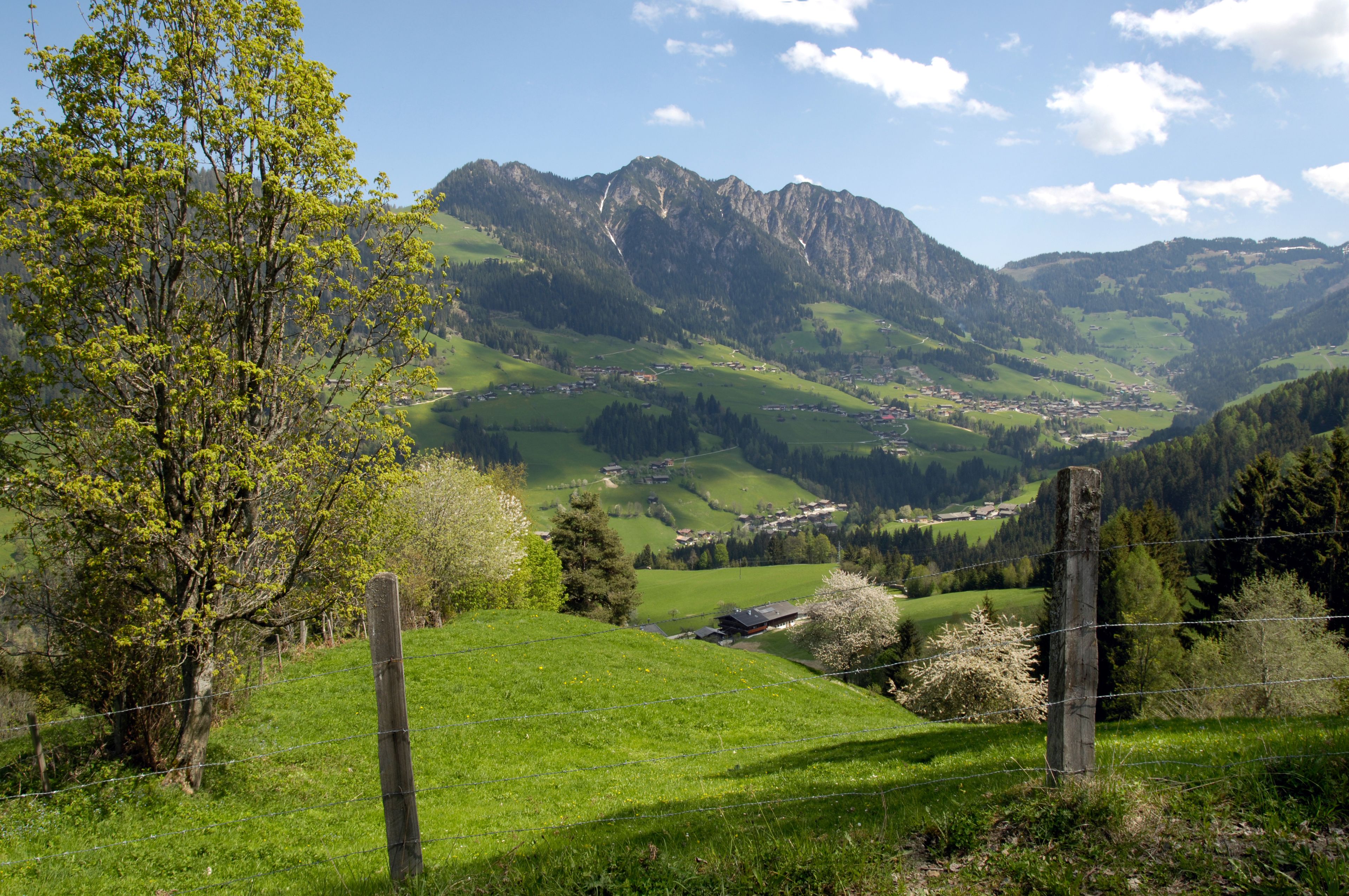 A mountainous landscape with a village nestled in a valley.