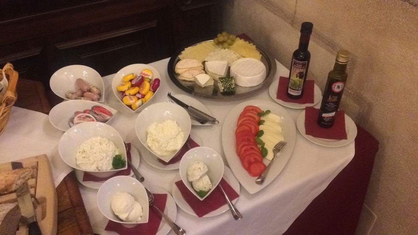 A table with various food items and bottles of wine.