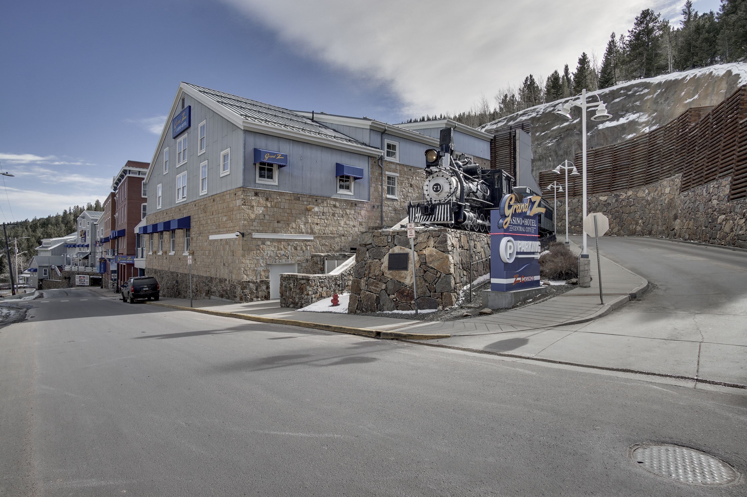 A building with a stone facade, a visible fire hydrant, and a sign for a casino/hotel.