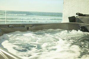 A hot tub with a view of the ocean.