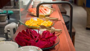 A buffet setup with various fruits and a water dispenser. - Royal Palace Hotel (Taipei)