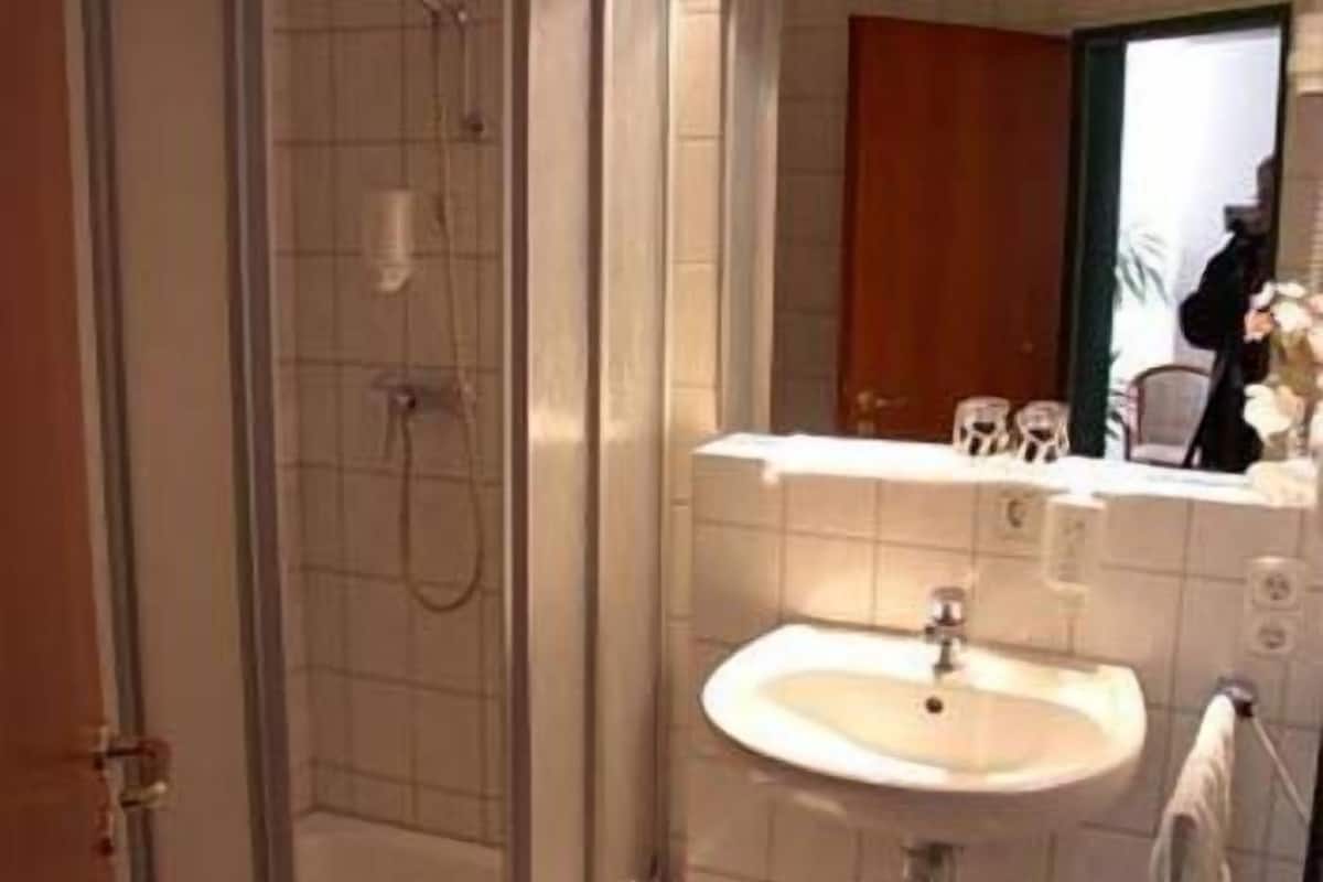 shower, rainfall showerhead, hair dryer, towels