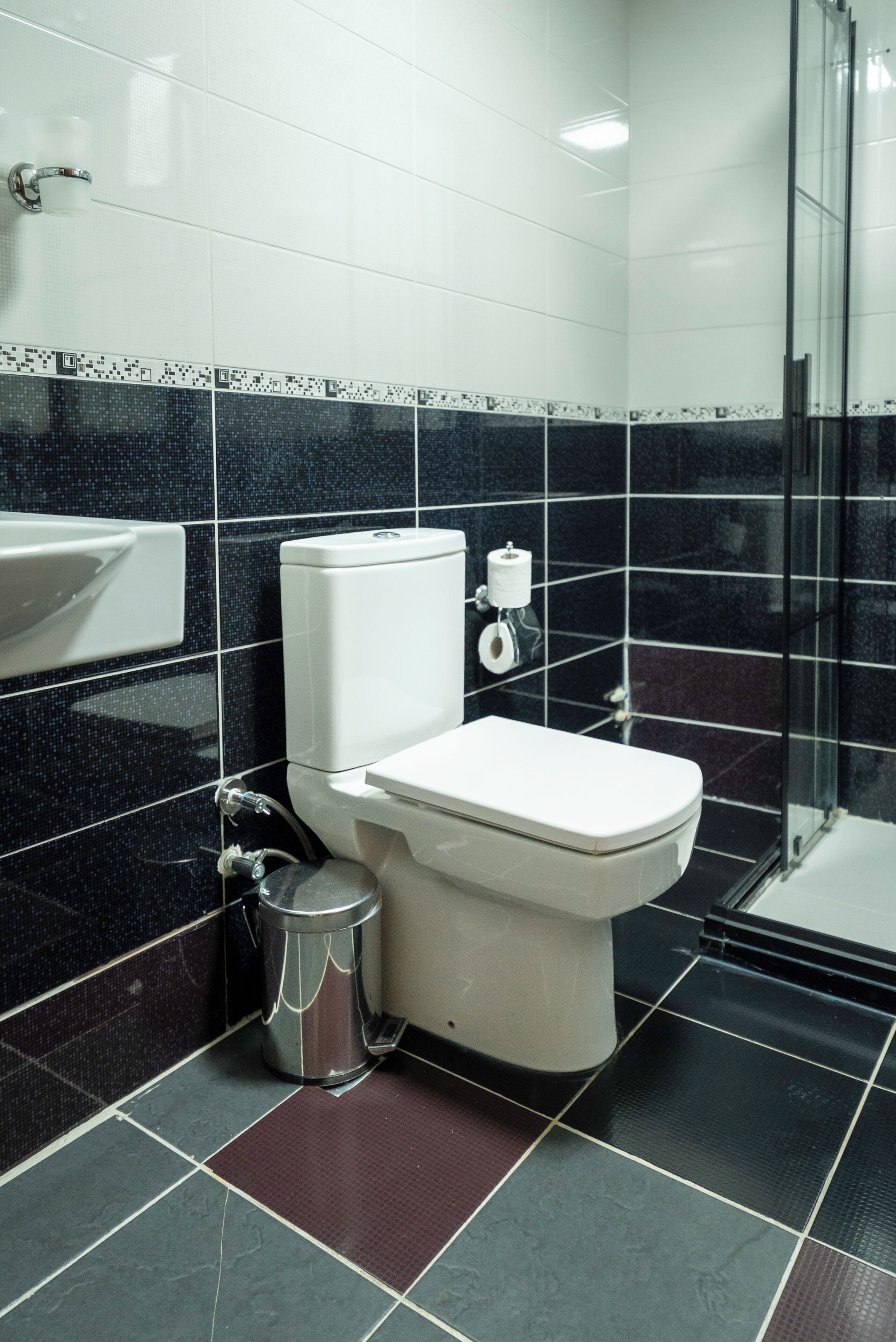 A bathroom with a toilet, sink, and shower.