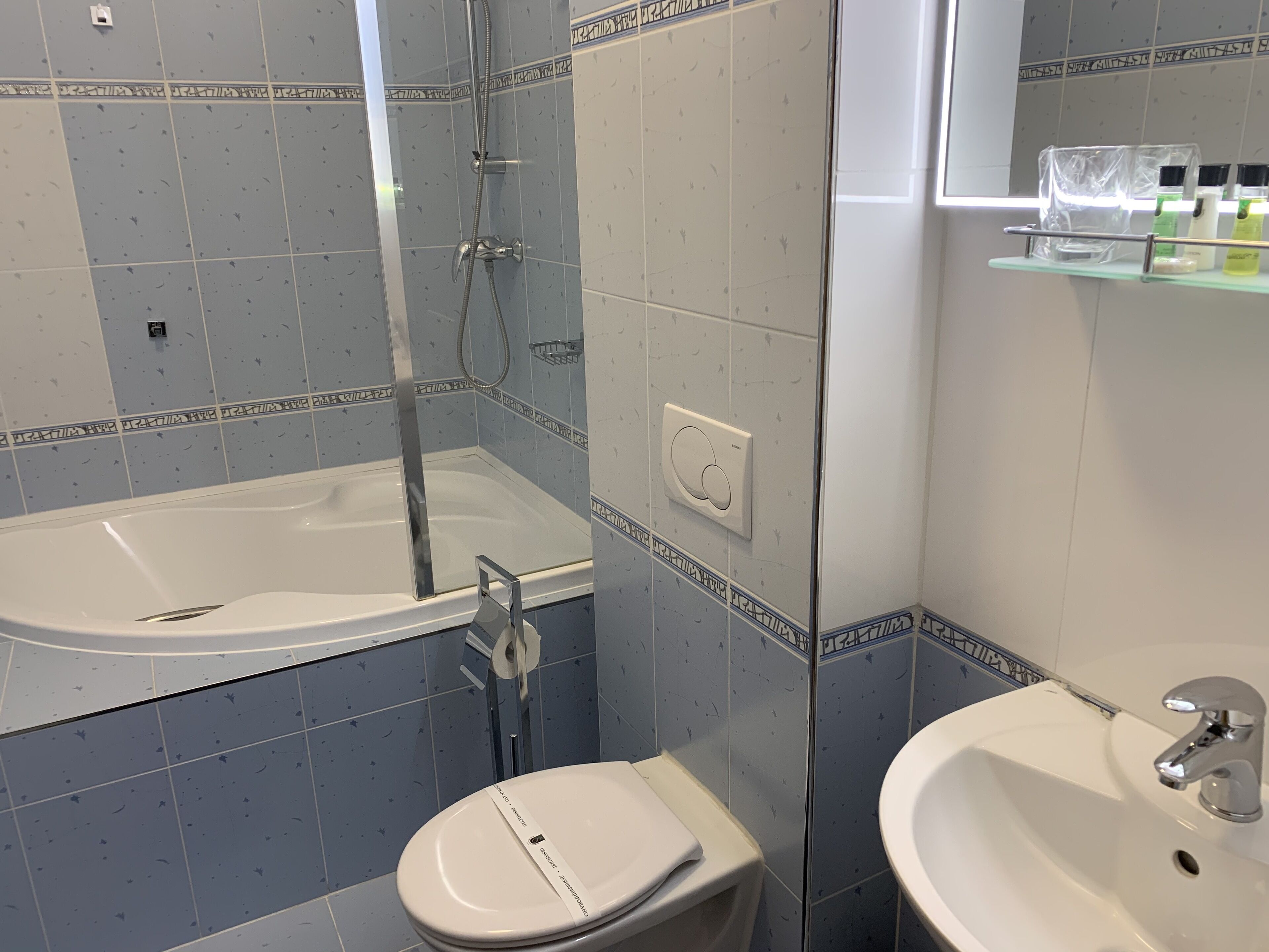 A bathroom with a bathtub, toilet, and sink.