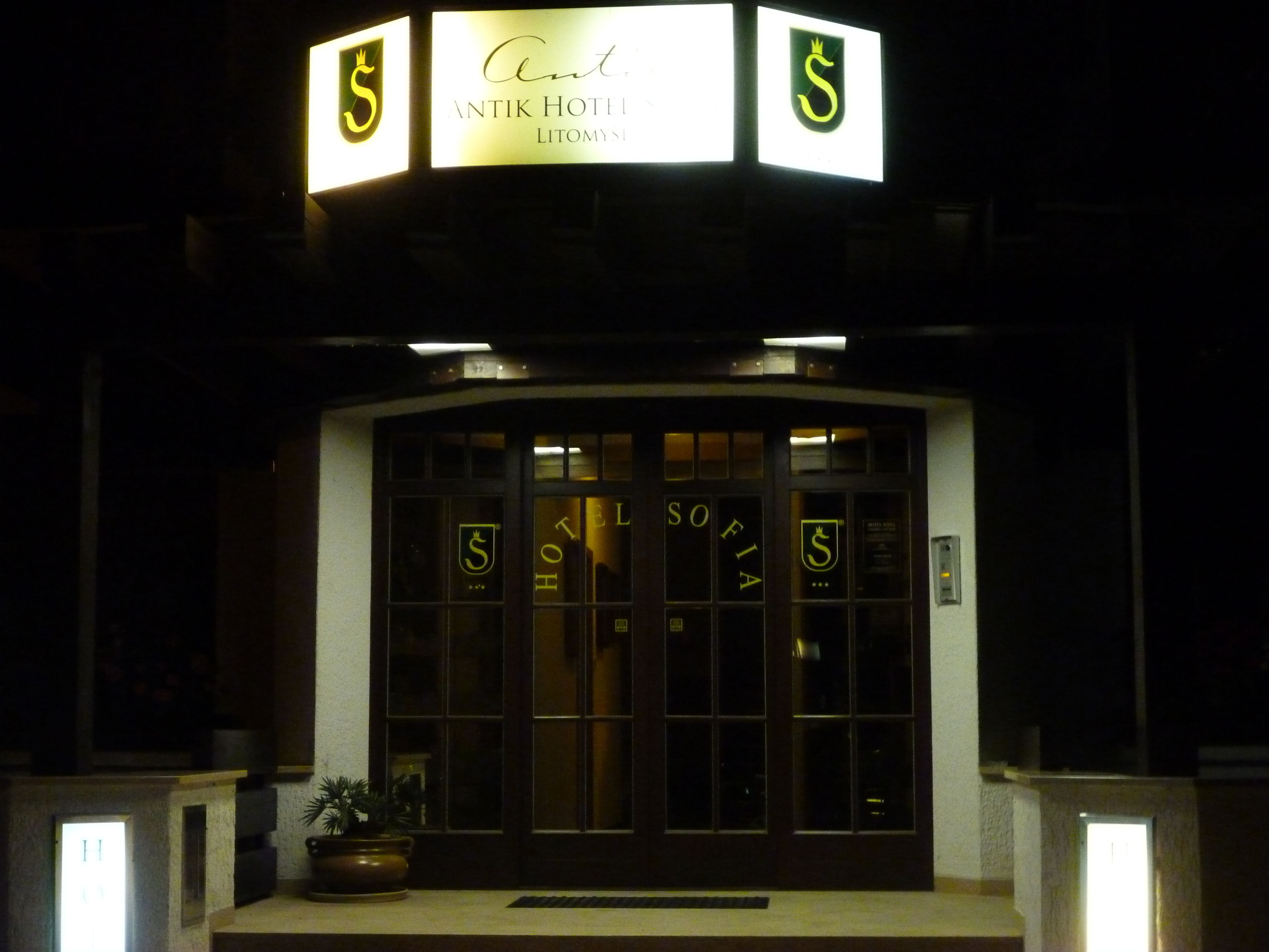 The exterior of the Antik Hotel with illuminated signage and a prominent entrance.