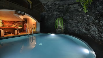 Indoor pool, a waterfall pool, pool loungers