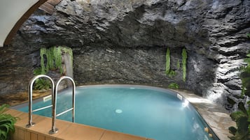 Enjoy a serene swim in our indoor pool surrounded by a natural rock wall.
