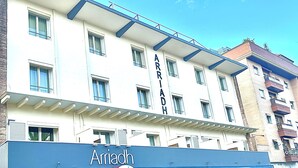 A multi-story hotel with the name 'Arriach' prominently displayed on the facade. - Arriadh (Córdoba)