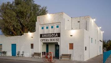 Amargosa Opera House features a distinctive white facade and a flat roof, with a prominent sign displaying its name.